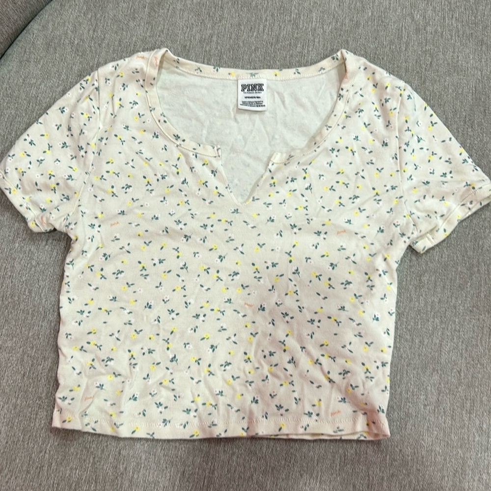 Yellow baby-t with yellow and white flowers on it